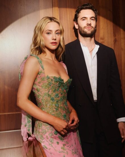Lili Reinhart radiant in a rose and green floral gown beside Tom Bateman at The Love Hypothesis New York premiere