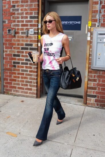 Lili Reinhart rocking a vintage graphic tank, flared jeans and an iced coffee in Red Hook, Brooklyn