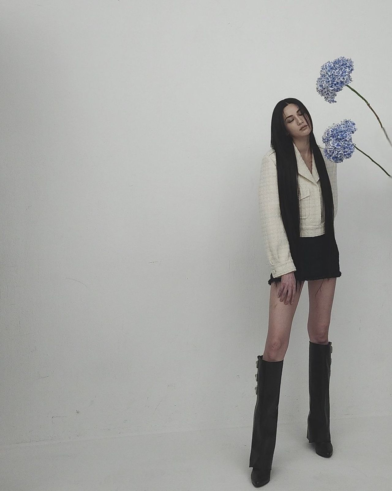 Nana in a black mini skirt and boots holding a Givenchy bag, Vogue Korea June 2024