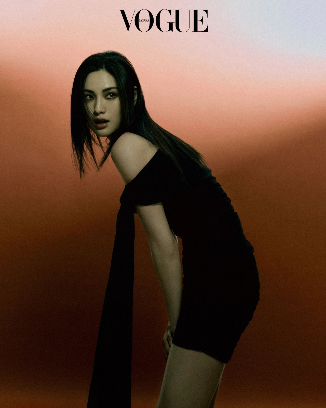 Nana in a black off-shoulder dress against a sunset backdrop, Vogue Korea