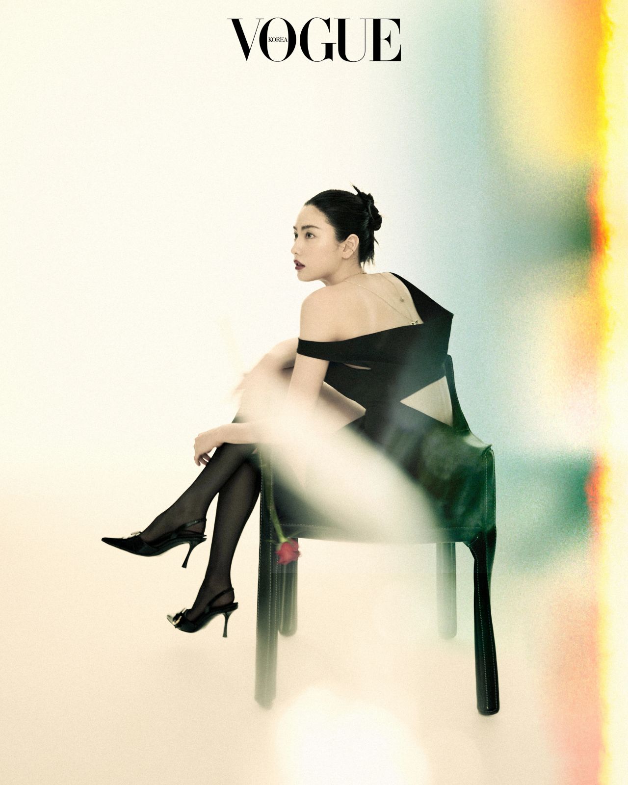 Nana seated in a black off-shoulder dress and heels, Vogue Korea editorial