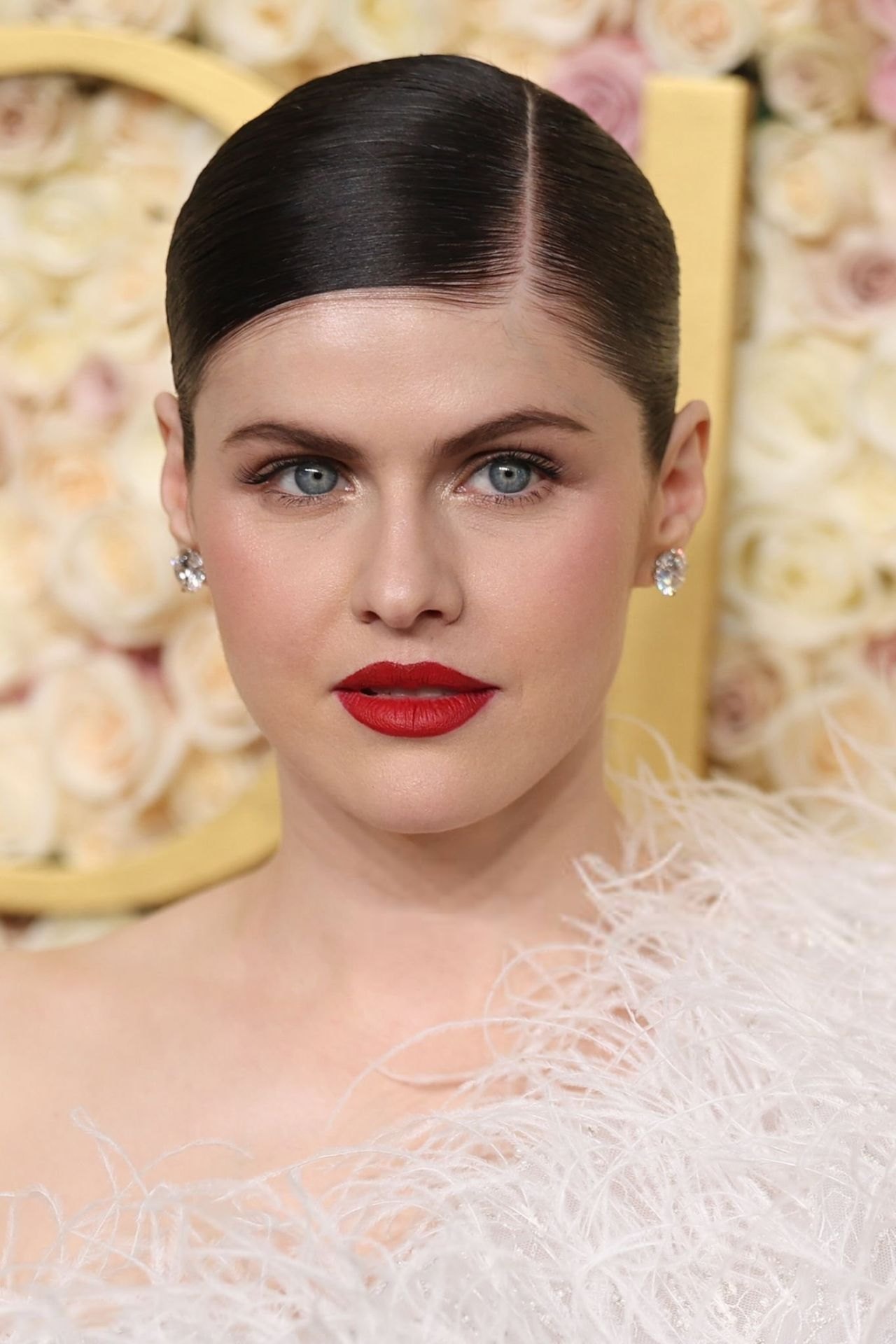 Alexandra Daddario close-up with a red lip at the Golden Globes 2025