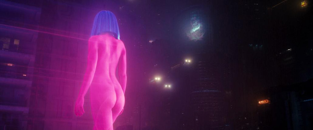 The naked hologram from the side, blue hair, city behind her