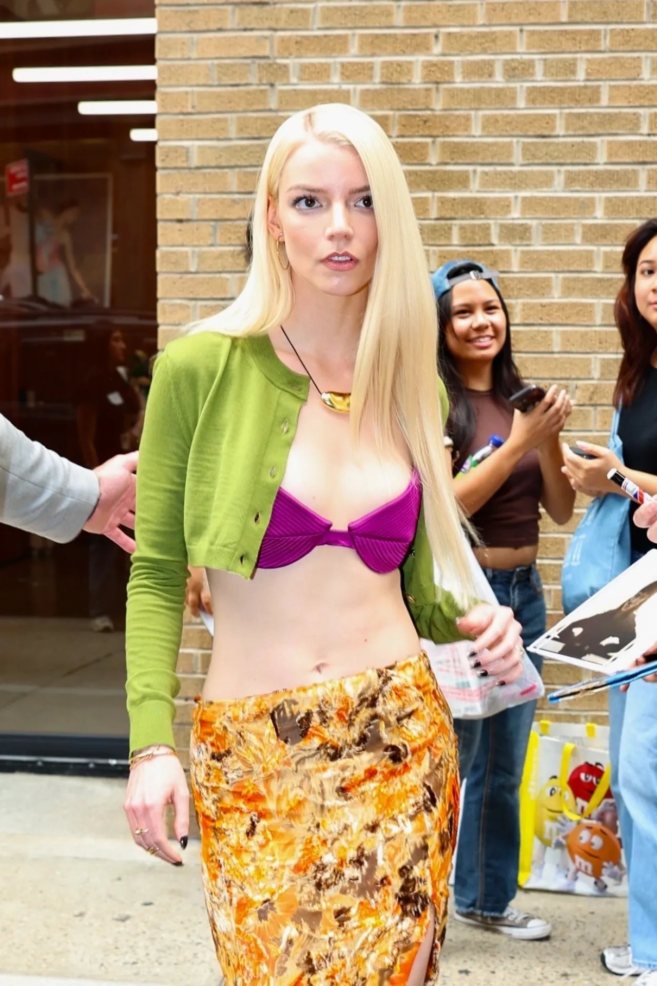 Anya Taylor-Joy in a purple bra top and green cardigan in SoHo, July 2026, photo 2