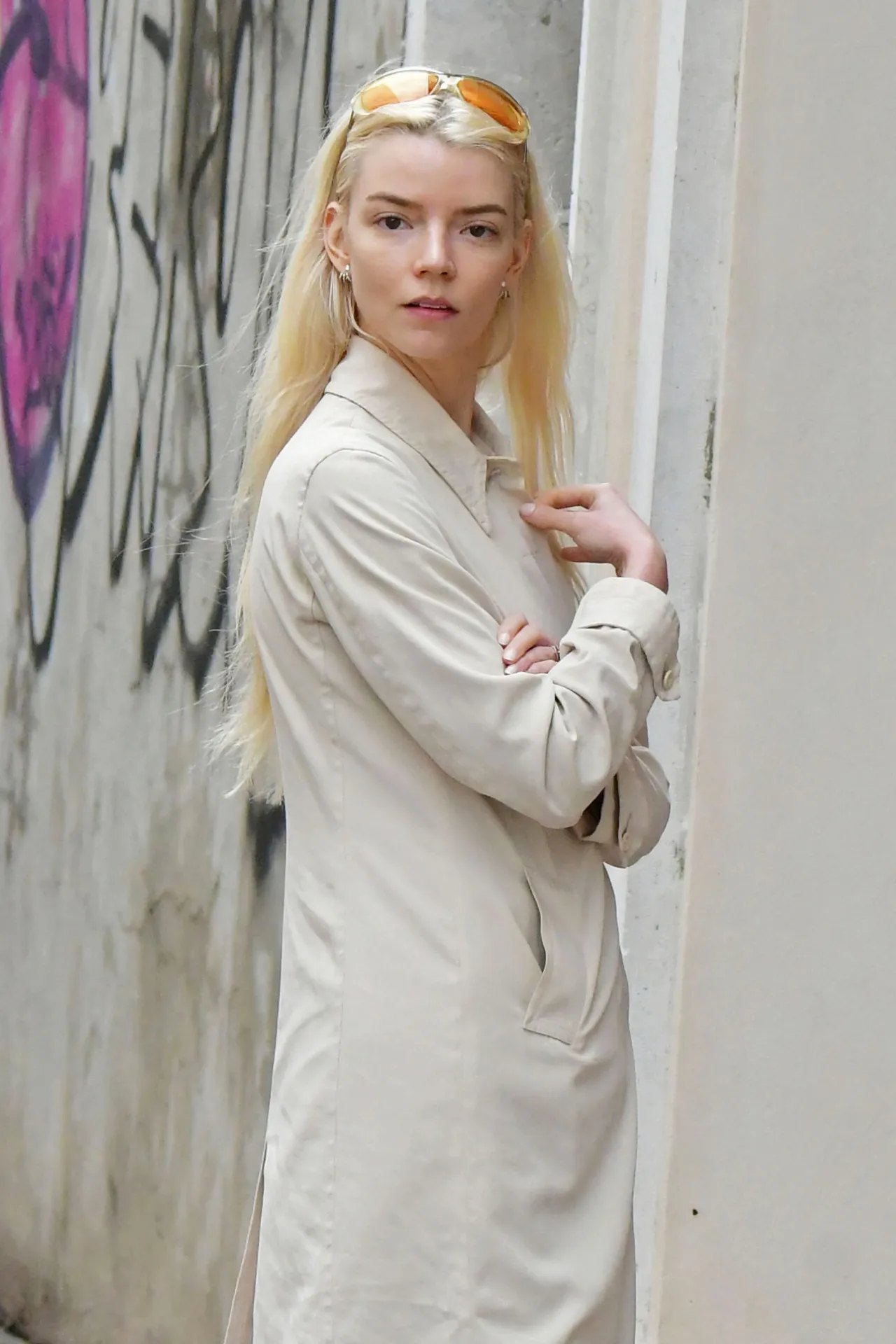 Anya Taylor-Joy in a light trench coat over a black mini dress, 2026, photo 4