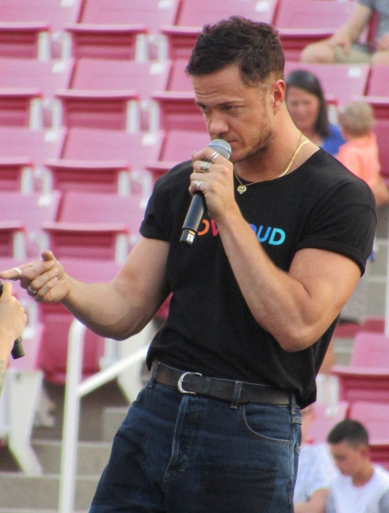 Dan Reynolds in a black LoveLoud T-shirt speaking onstage with a microphone at LoveLoud 2018