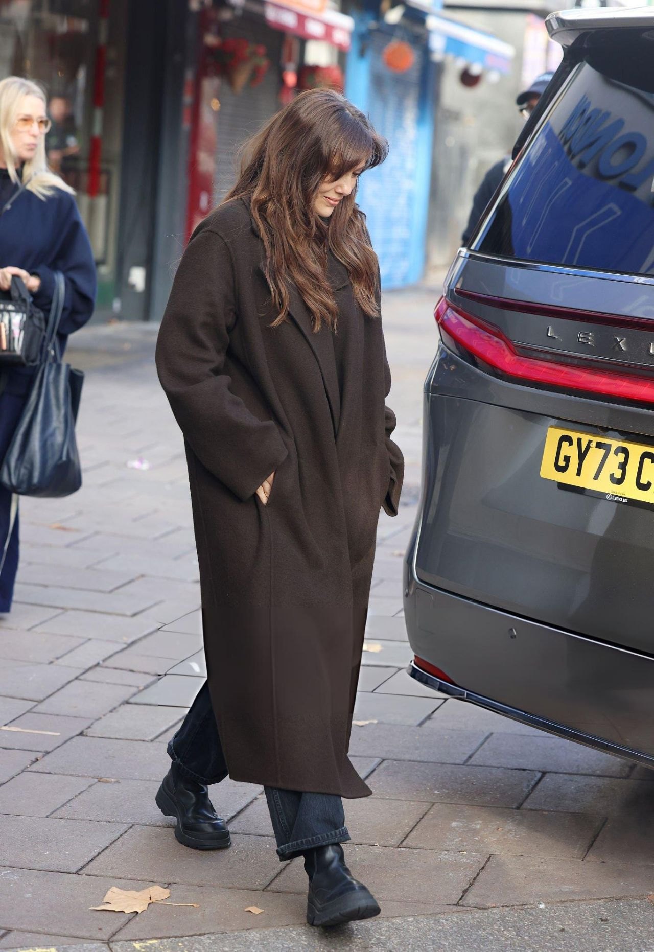 Elizabeth Olsen in a long brown coat leaving Heart Radio studios in London, 2025, photo 3