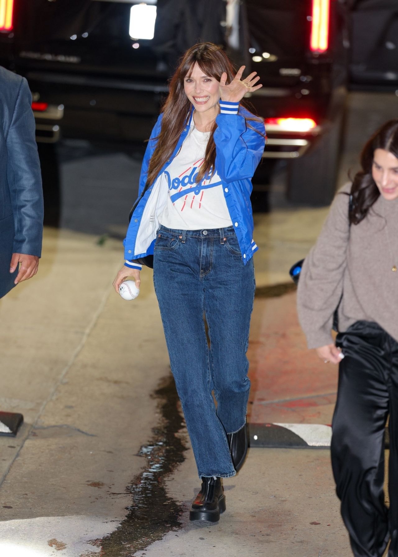 Elizabeth Olsen in a Dodgers jacket outside Jimmy Kimmel Live, 2025