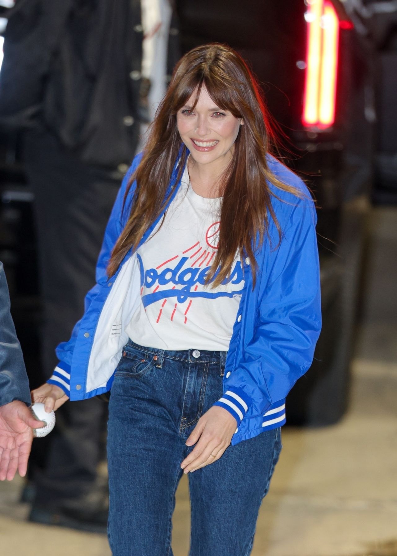 Elizabeth Olsen in a Dodgers jacket outside Jimmy Kimmel Live, 2025, photo 2