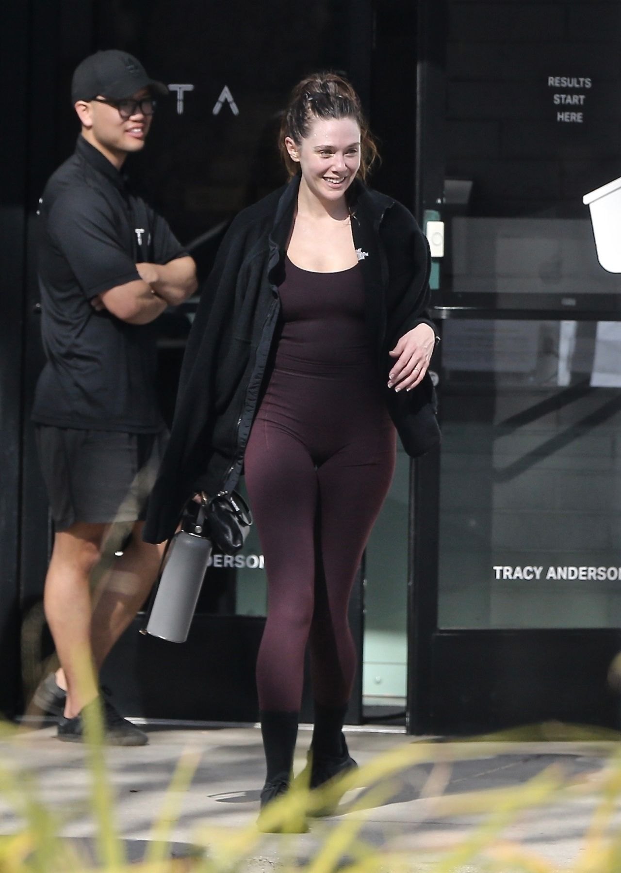 Elizabeth Olsen leaving the gym in a maroon athletic outfit, December 2024