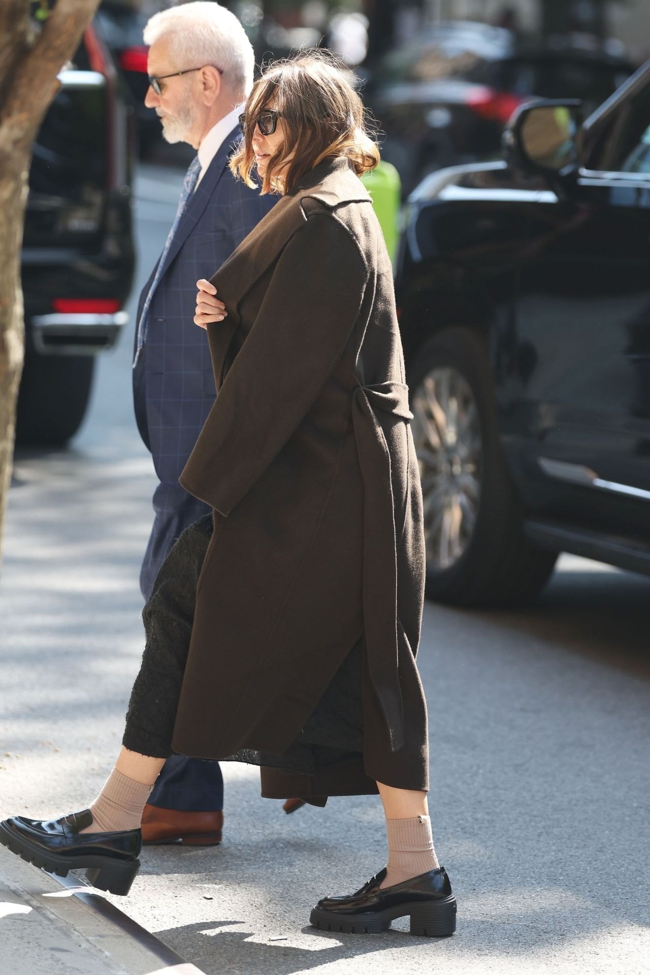 Elizabeth Olsen walking through Tribeca in a black coat, September 2024