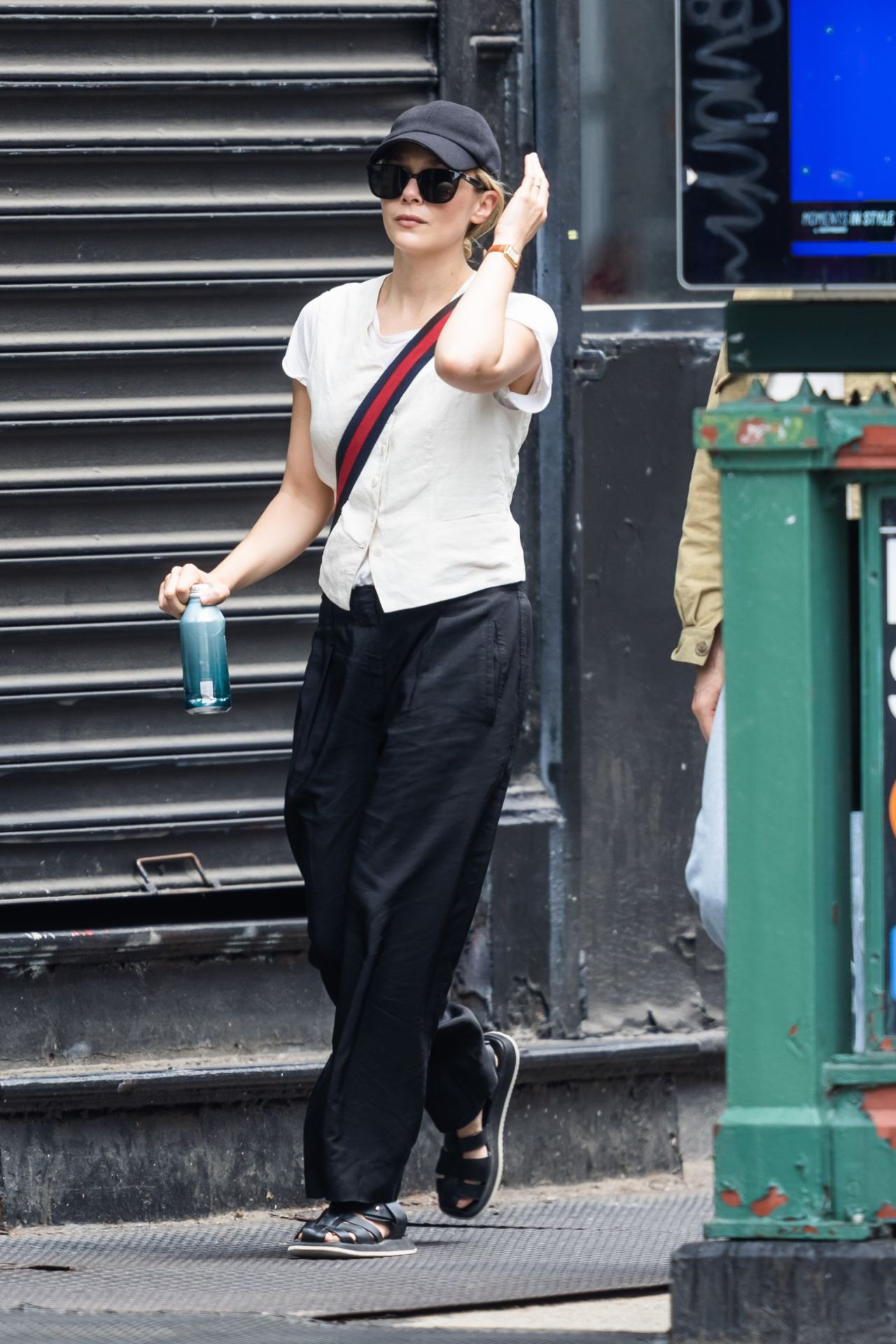 Elizabeth Olsen in a white T-shirt and black trousers in New York, June 2023, photo 2