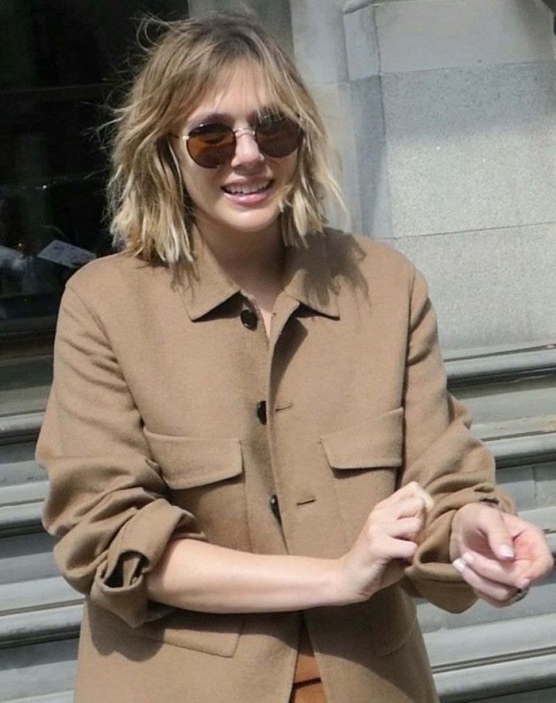Elizabeth Olsen out in London in a camel jacket, April 2022