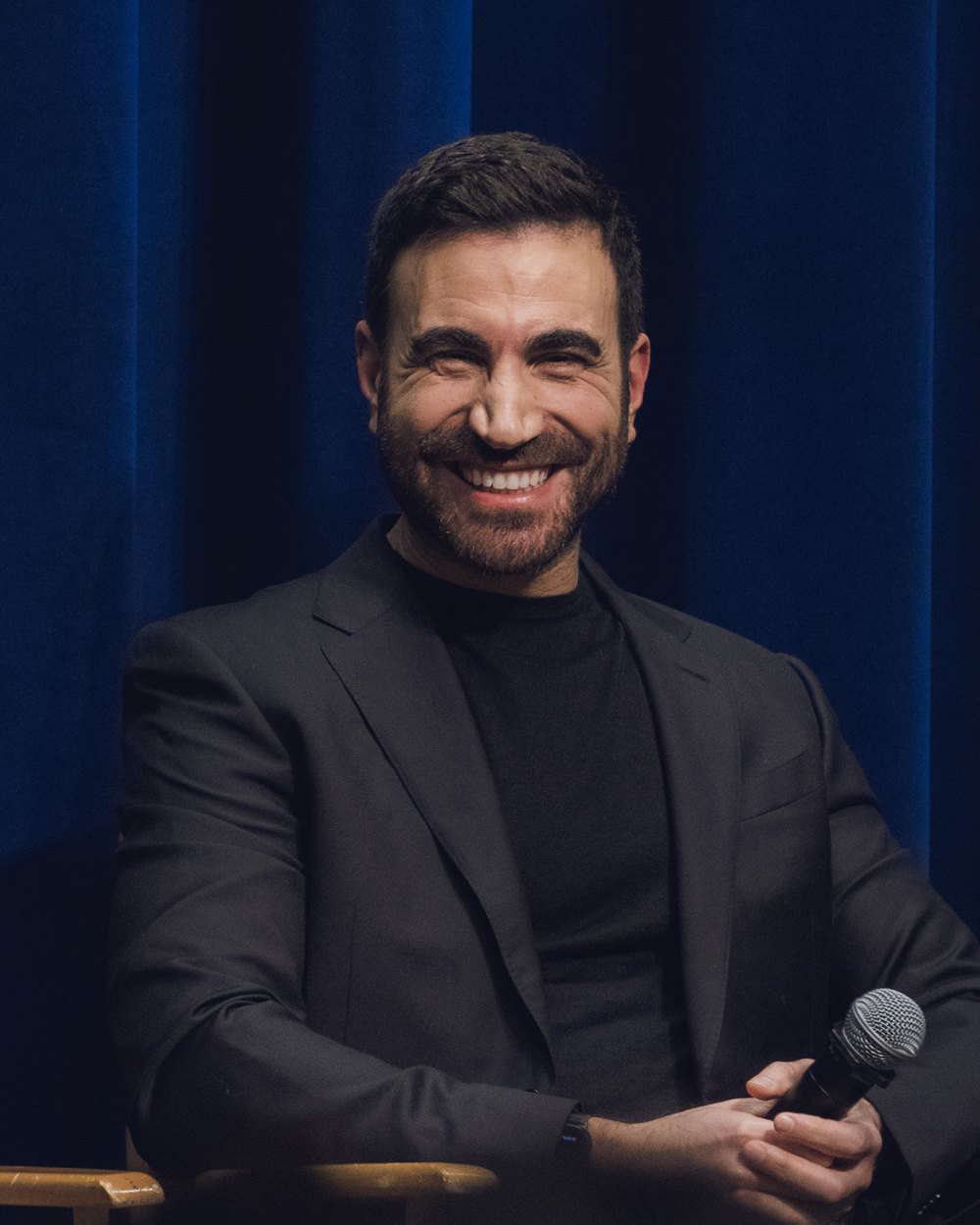 Brett Goldstein smiling on stage at a PaleyLive Shrinking panel in Beverly Hills in 2024