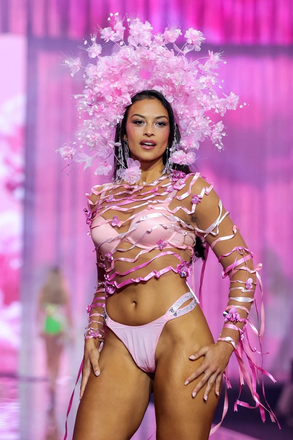 Devyn Garcia in pink with a floral headpiece on the Victoria's Secret runway, unedited photo