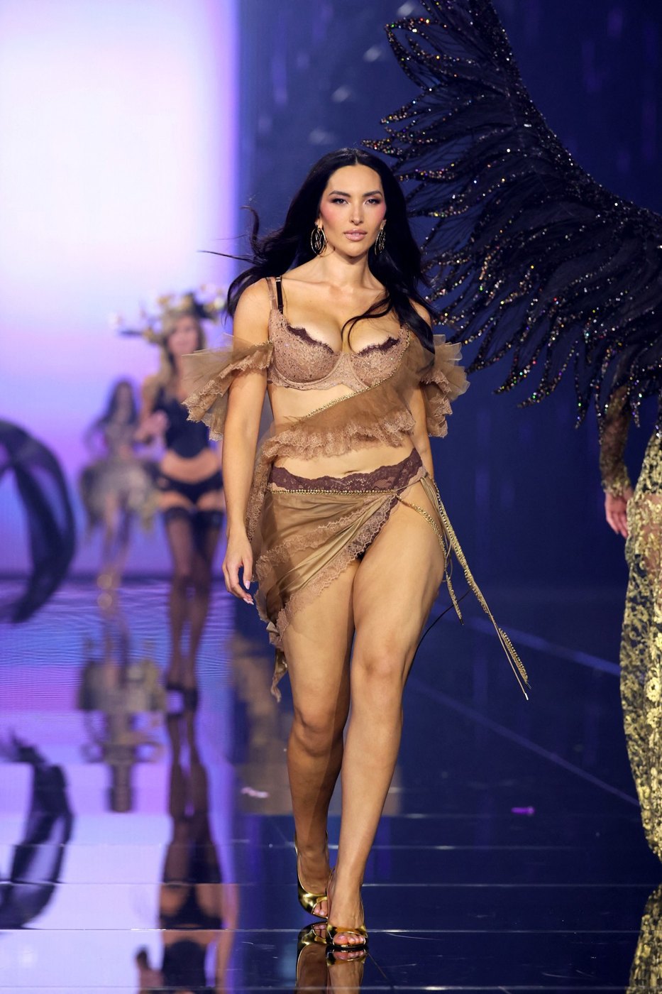 Yumi Nu in a bronze fringe look on the Victoria's Secret runway, unedited photo