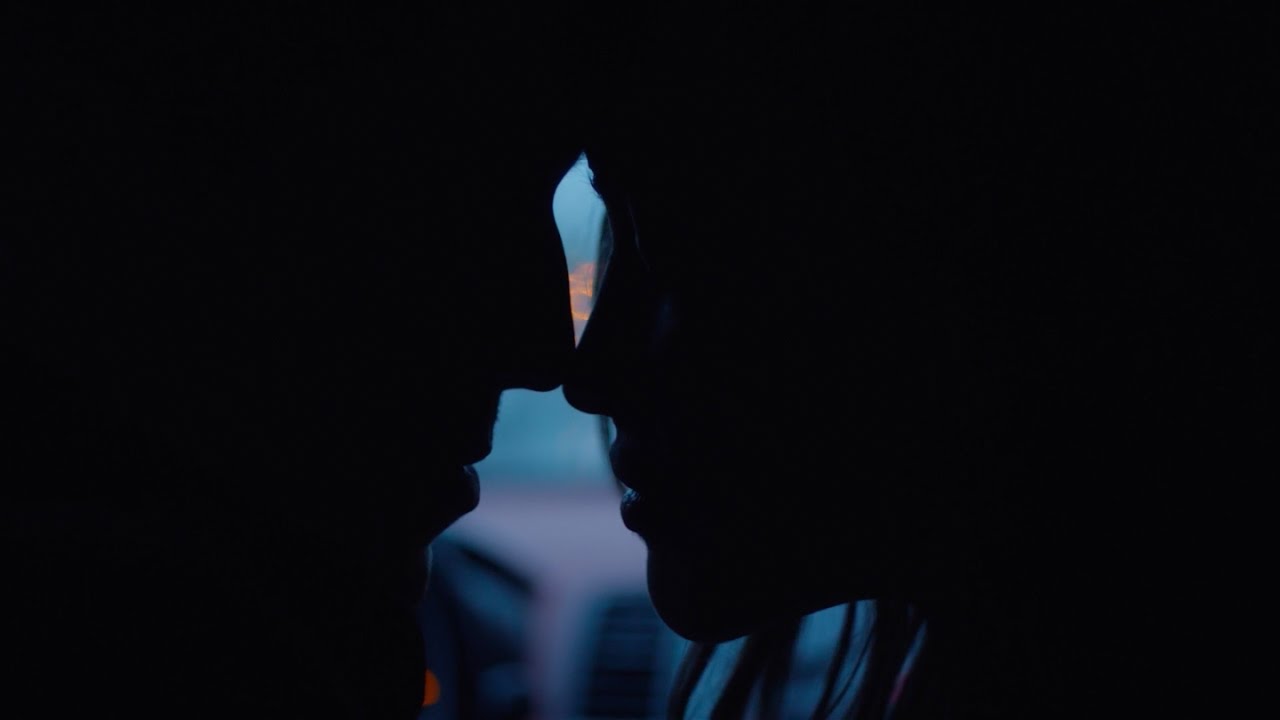 Sarah Stephens in profile, about to kiss, in Lauv's official video for The Other