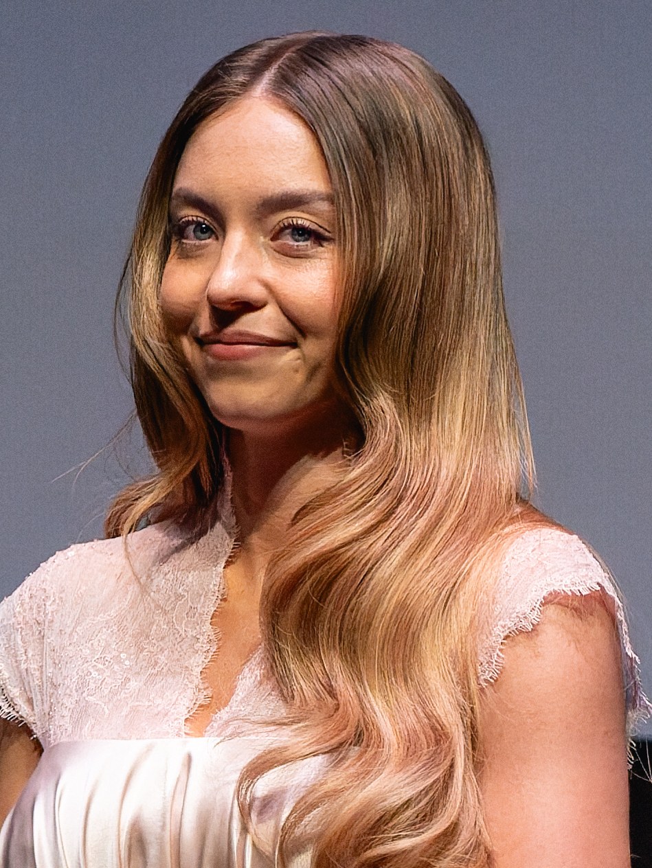 Sydney Sweeney smiling in a pale pink lace-trimmed dress at the BFI London Film Festival premiere of Christy, October 2025